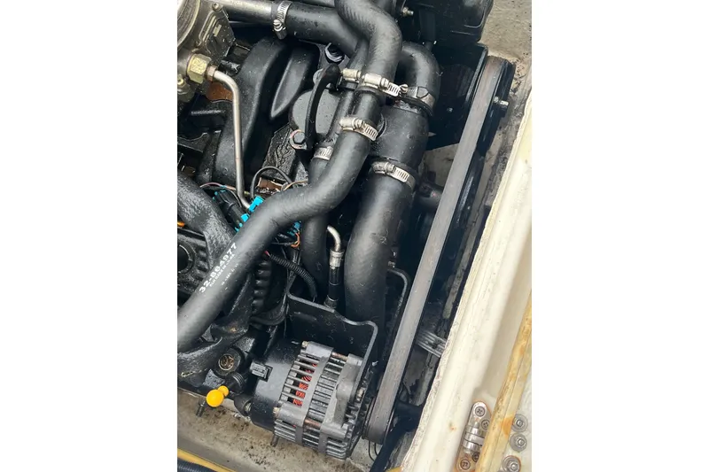 Slide: The Image of Engine compartment of a 2006 Trophy 2359 Hardtop boat, showing hoses and components. - 26