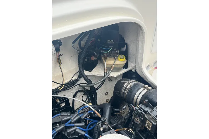 Slide: The Image of Engine compartment of a 2006 Trophy 2359 Hardtop boat, showing wiring and components. - 28