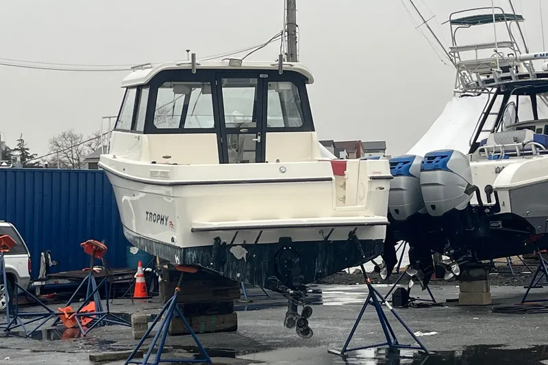 Slide: The Image of 2006 Trophy 2359 Hardtop boat on stands in a marina yard. - 29