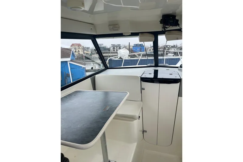 Slide: The Image of Interior of 2006 Trophy 2359 Hardtop boat with table and seating. - 5