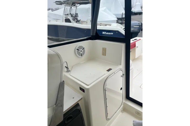Slide: The Image of 2006 Trophy 2359 Hardtop boat interior with seating and storage compartment. - 6
