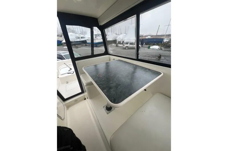 Slide: The Image of Interior of 2006 Trophy 2359 Hardtop boat with table and seating area. - 7