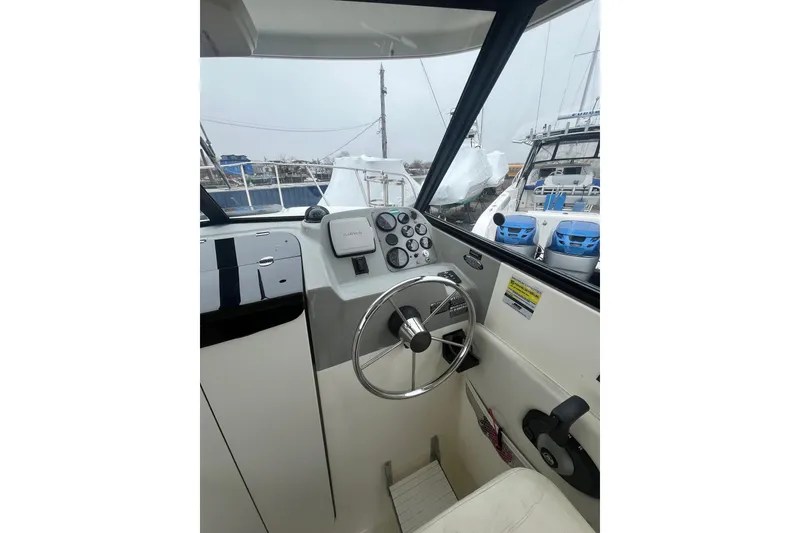 Slide: The Image of 2006 Trophy 2359 Hardtop boat helm with steering wheel and instrument panel. - 8