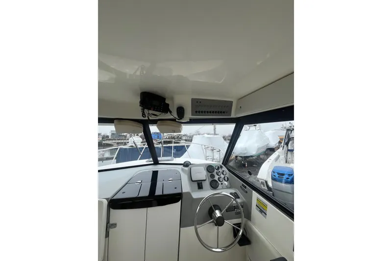 Slide: The Image of Interior view of 2006 Trophy 2359 Hardtop boat cockpit with steering wheel and controls. - 9