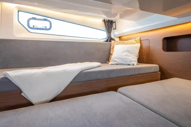 Slide: The Image of 2026 Beneteau Antares 11 interior cabin with cozy seating and modern design. - 15