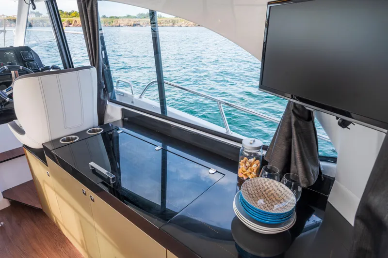 Slide: The Image of Interior of 2026 Beneteau Antares 11 Coupe with modern amenities and ocean view. - 18