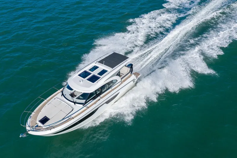 Slide: The Image of 2026 Beneteau Antares 11 Coupe cruising on open water, aerial view. - 2