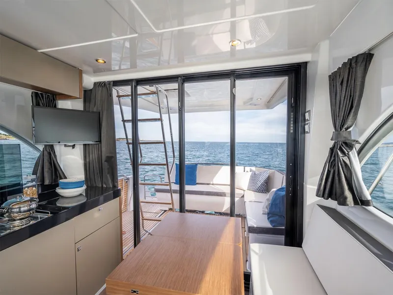 Slide: The Image of Manufacturer Provided Image: Interior of 2025 Beneteau Antares 11 yacht with ocean view through sliding doors. - 7
