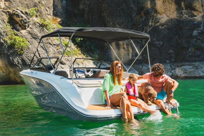 Slide: The Image of Manufacturer Provided Image: Family enjoying a day on a 2025 Bayliner V20i boat in scenic waters. - 2