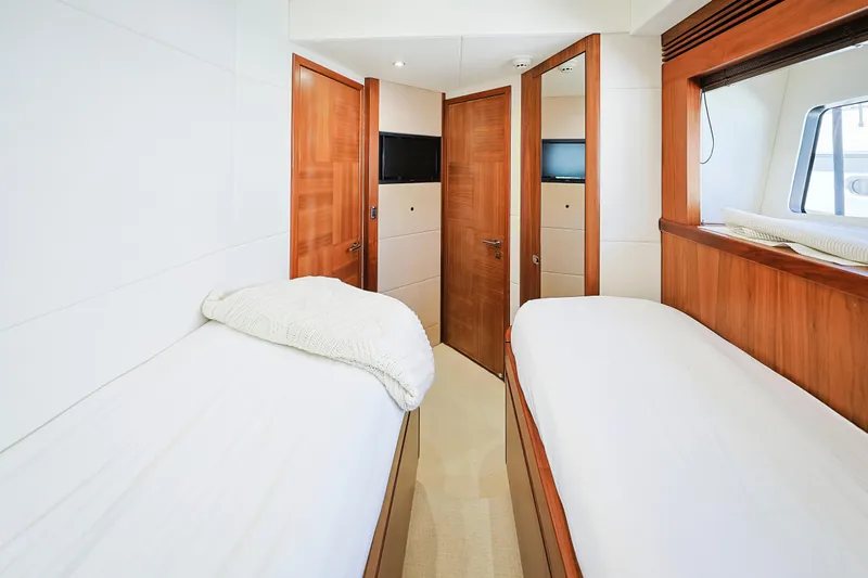 Slide: The Image of Twin cabin interior of 2015 Sunseeker 75 Yacht with wooden accents and cozy beds. - 14