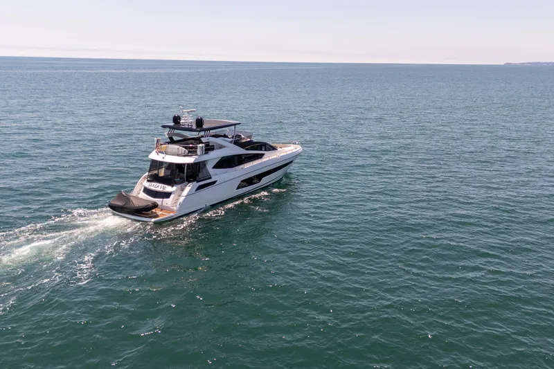 Slide: The Image of 2015 Sunseeker 75 Yacht cruising on open sea under clear skies. - 3
