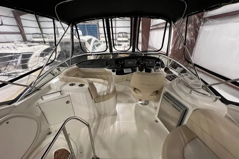 Slide: The Image of Interior view of 2012 Meridian 341 Sedan yacht cockpit with steering wheel and seating. - 23