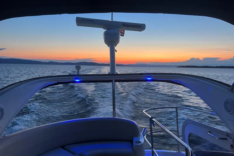 Slide: The Image of Meridian 341 Sedan boat cruising at sunset, 2012 model, serene ocean view. - 26