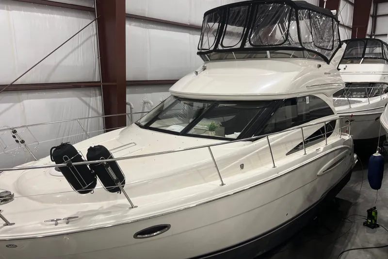 Slide: The Image of 2012 Meridian 341 Sedan yacht docked at marina under cloudy sky. - 3