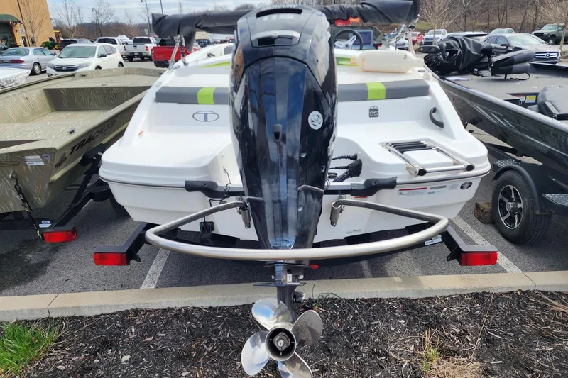 Slide: The Image of 2023 Tahoe T18 boat with outboard motor in a parking lot. - 4