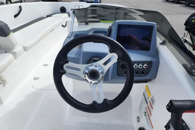 Slide: The Image of Steering wheel and dashboard of 2023 Tahoe T18 boat, featuring modern controls and seating. - 5