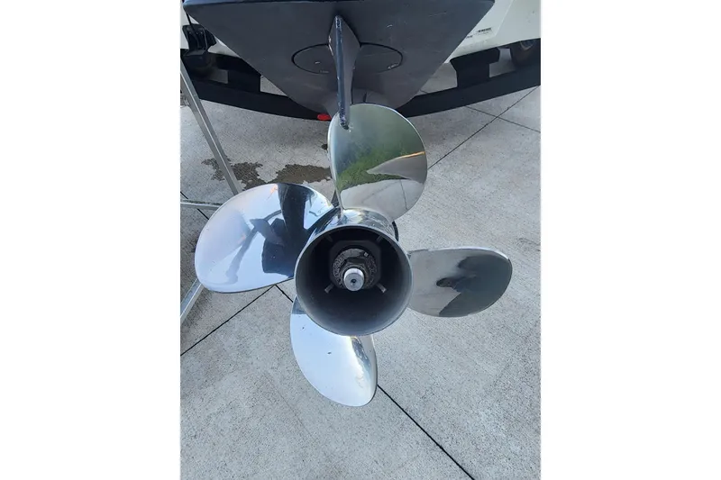 Slide: The Image of 2023 Tahoe T18 boat propeller on concrete surface, showcasing shiny metal blades. - 8