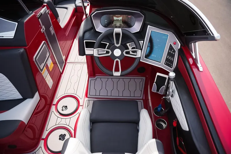 Slide: The Image of 2019 MasterCraft X24 boat cockpit with modern steering and digital controls. - 12