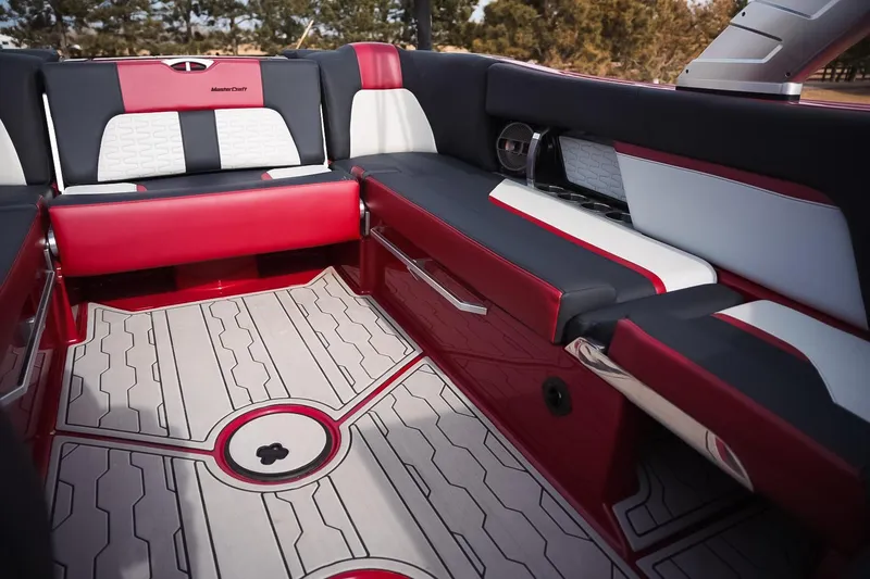 Slide: The Image of 2019 MasterCraft X24 boat interior with red and white seating and stylish flooring. - 13
