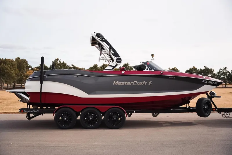 Slide: The Image of 2019 MasterCraft X24 boat on trailer, parked outdoors, side view. - 5