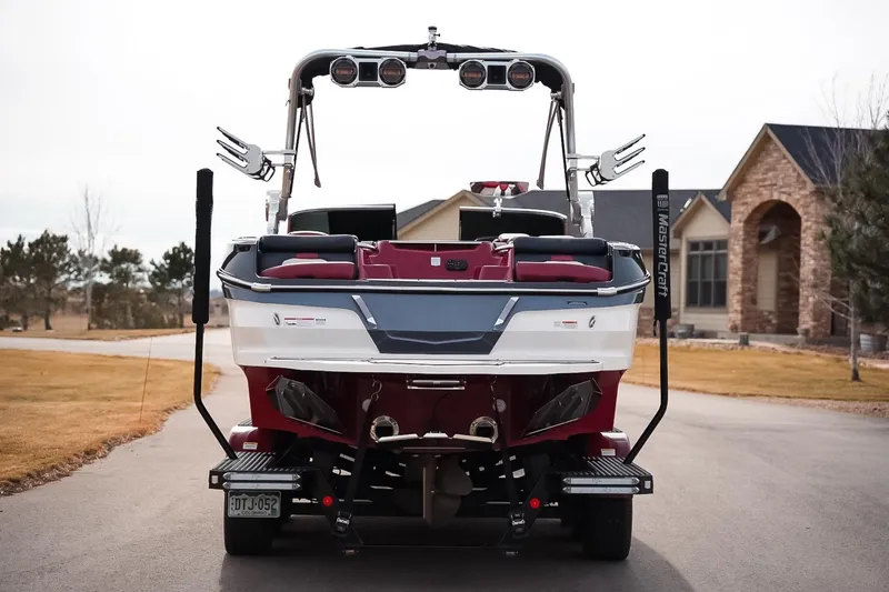 Slide: The Image of 2019 MasterCraft X24 boat on trailer, parked in residential driveway. - 6