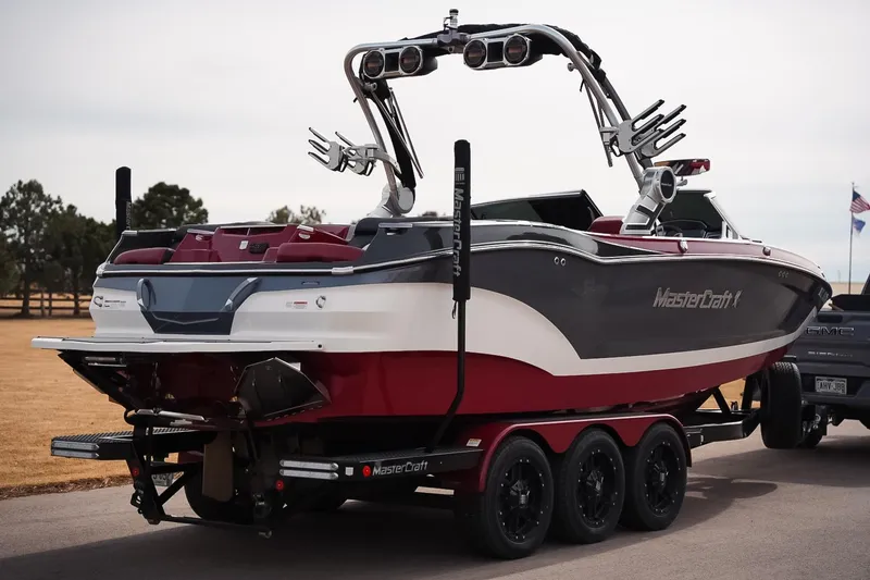 Slide: The Image of 2019 MasterCraft X24 boat on trailer, featuring sleek design and vibrant colors. - 7