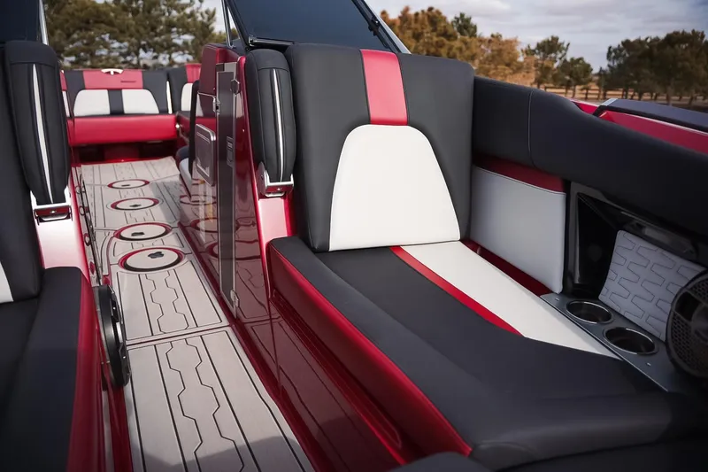 Slide: The Image of 2019 MasterCraft X24 boat interior with red, black, and white seating and stylish flooring. - 9