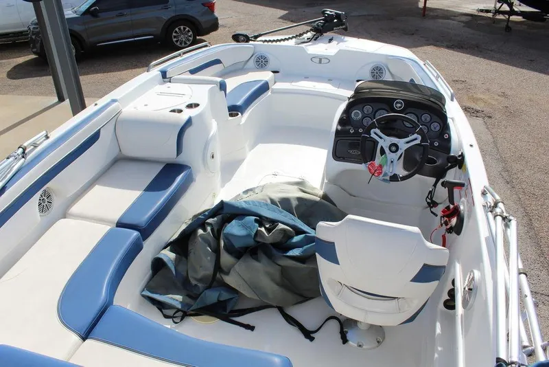 Slide: The Image of 2020 Tahoe 215 Xi boat interior with blue and white seating, steering console, and equipment. - 10