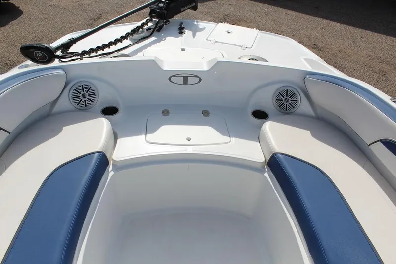 Slide: The Image of 2020 Tahoe 215 Xi boat interior with blue and white seating and speakers. - 14
