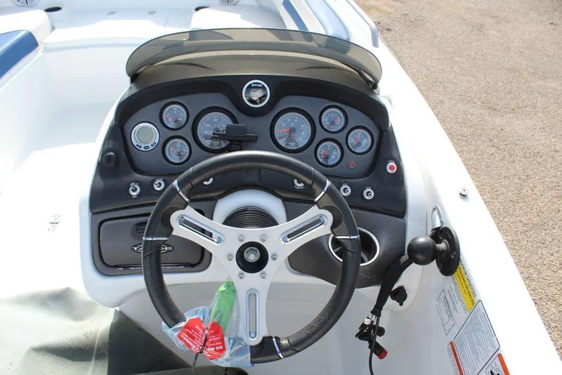 Slide: The Image of Steering console of a 2020 Tahoe 215 Xi boat with gauges and controls. - 15