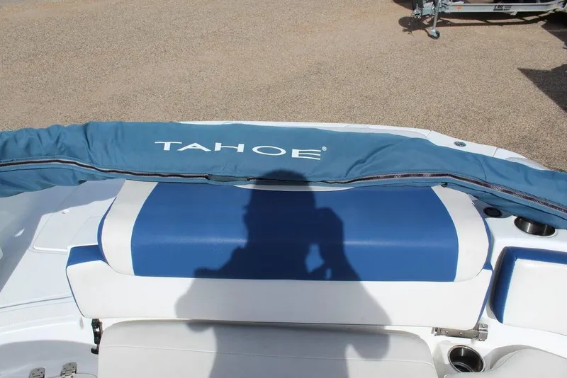 Slide: The Image of 2020 Tahoe 215 Xi boat interior with blue and white seating, shadow visible. - 17