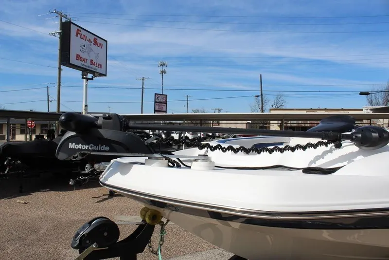 Slide: The Image of 2020 Tahoe 215 Xi boat at Fun-N-Sun Boat Sales dealership under clear blue sky. - 8