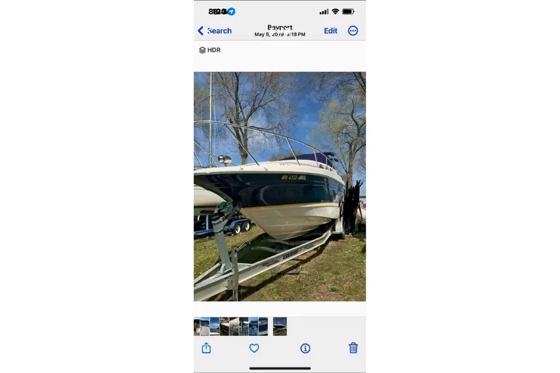 Slide: The Image of 2005 Regal 2750 boat on trailer, parked outdoors under clear blue sky. - 10