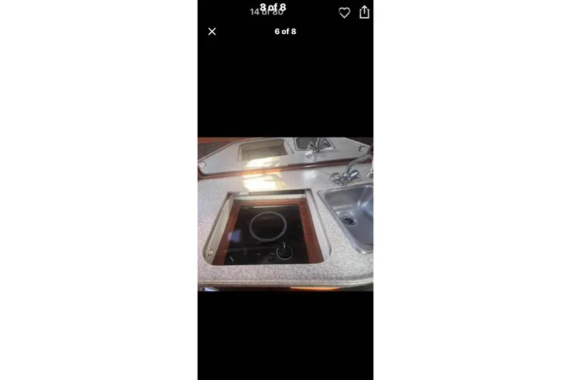 Slide: The Image of 2005 Regal 2750 boat kitchen with stove and sink. - 2