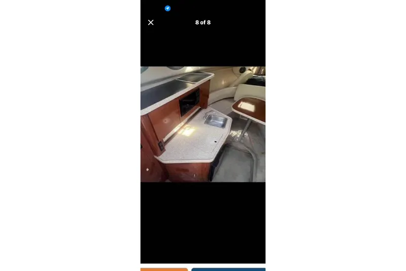 Slide: The Image of 2005 Regal 2750 boat interior with kitchenette and seating area. - 3