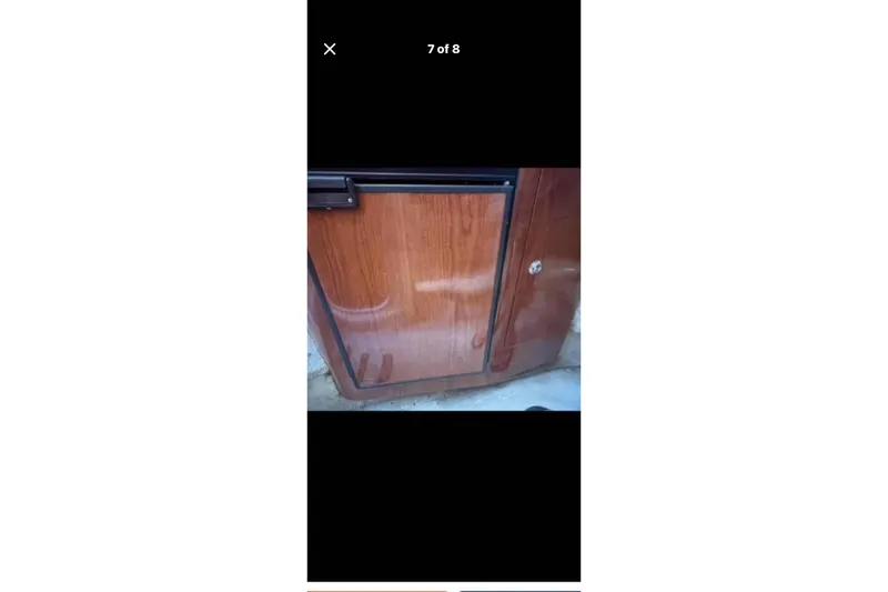 Slide: The Image of Wooden cabinet door on a 2005 Regal 2750 boat interior. - 4