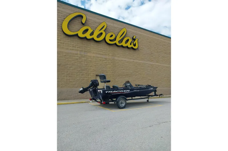 Slide: The Image of 2019 Tracker Pro Team 170 TX boat parked outside Cabela's store. - 3