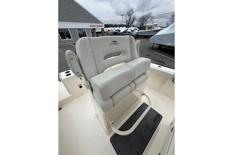 Slide: The Image of 2022 Cobia 220 Center Console boat with cushioned seating and armrests. - 10