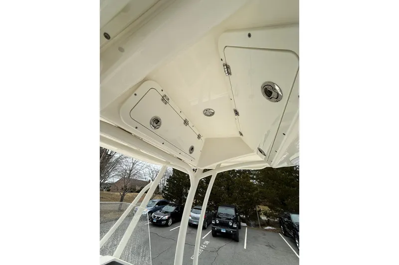 Slide: The Image of 2022 Cobia 220 Center Console boat with overhead storage compartments. - 14