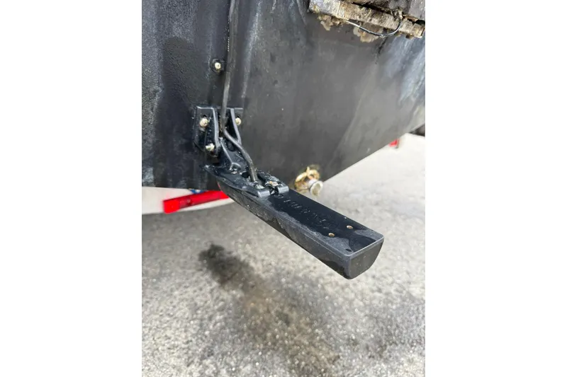 Slide: The Image of 2022 Cobia 220 Center Console boat transom detail with trim tab and wiring. - 22