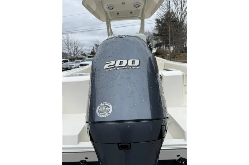 Slide: The Image of 2022 Cobia 220 Center Console with 200 horsepower engine, wet from rain. - 24