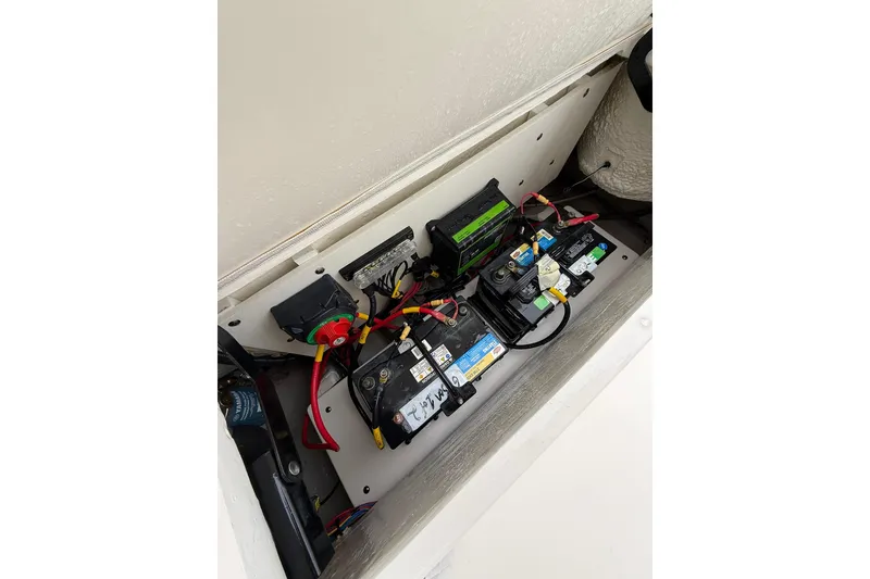 Slide: The Image of Battery compartment of 2022 Cobia 220 Center Console boat, showing wiring and connections. - 6
