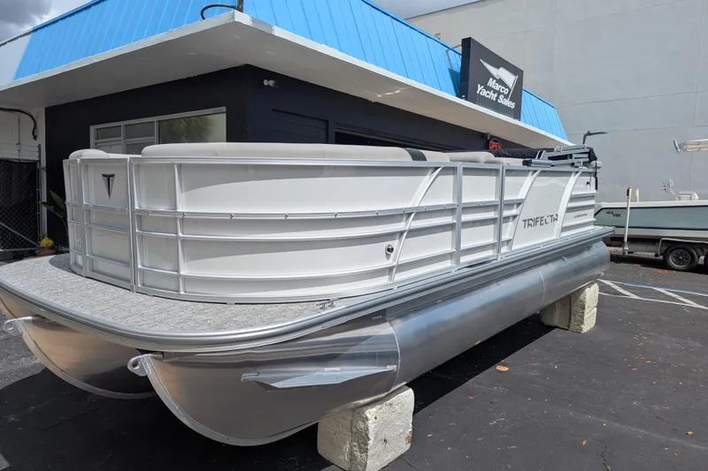 Slide: The Image of 2026 Trifecta 20CLE pontoon boat displayed at Marco Yacht Sales dealership. - 5