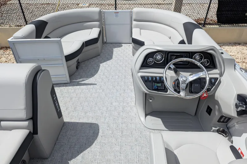 Slide: The Image of Interior of 2026 Trifecta 20CLE pontoon boat with modern steering console and plush seating. - 8