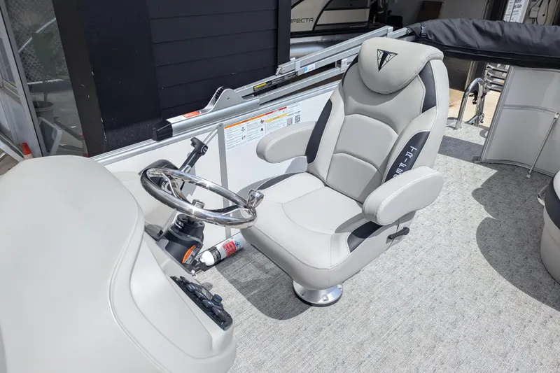 Slide: The Image of Captain's chair and steering wheel of 2026 Trifecta 20CLE pontoon boat. - 9