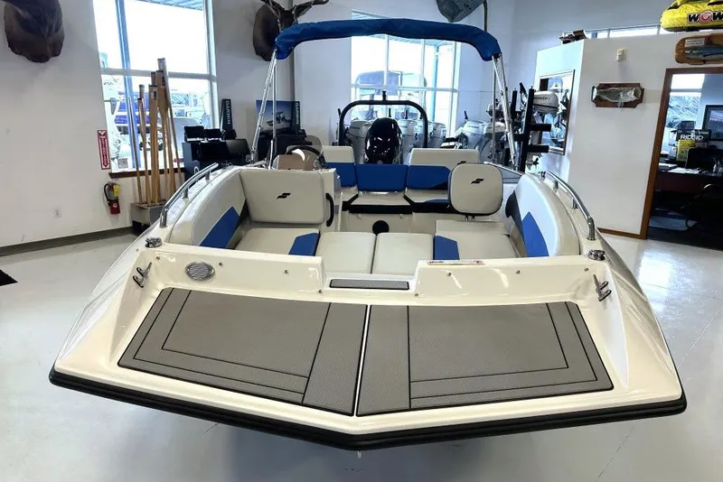 Slide: The Image of 2026 Starcraft SV 16 OB boat with blue seating, displayed indoors. - 2