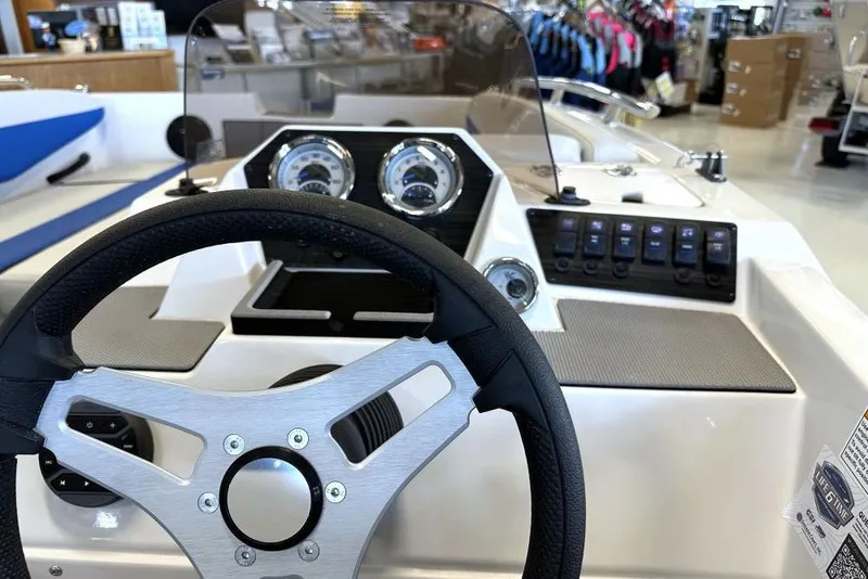 Slide: The Image of Steering wheel and dashboard of 2026 Starcraft SV 16 OB boat in showroom. - 4