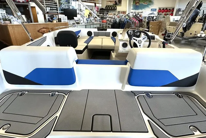 Slide: The Image of 2026 Starcraft SV 16 OB boat interior with blue and white seating, steering wheel, and storage compartments. - 5