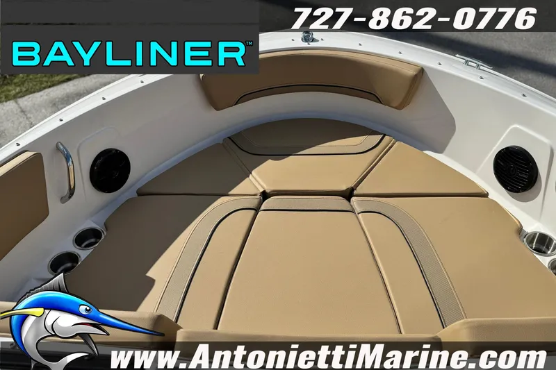 Slide: The Image of 2026 Bayliner V20 boat interior with tan seating, cup holders, and speakers. - 26