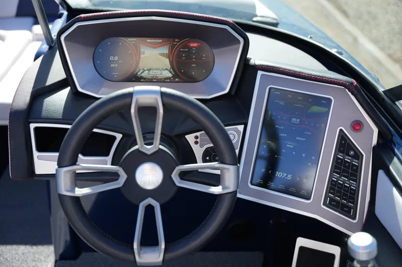Slide: The Image of Dashboard of a 2019 MasterCraft X24 boat with digital displays and steering wheel. - 13